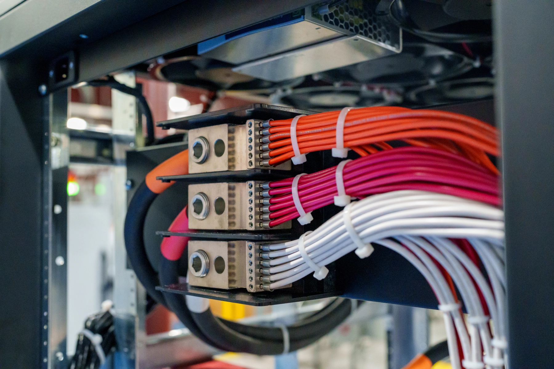 Three-phase AC power distribution inside the rack, with one distribution block per phase wired out to the power supplies.