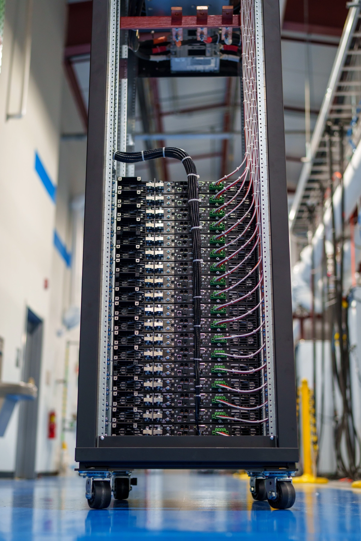 Rear view of rack with covers and panels removed, showing Ethernet harness running up the middle to each power supply's LXI TCP/IP Ethernet port, with AC input wiring on the right.