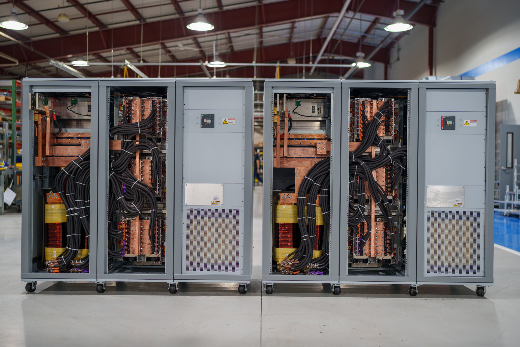Rear view of two 250 kW, 6000 Adc MT Series DC power supply with covers removed.