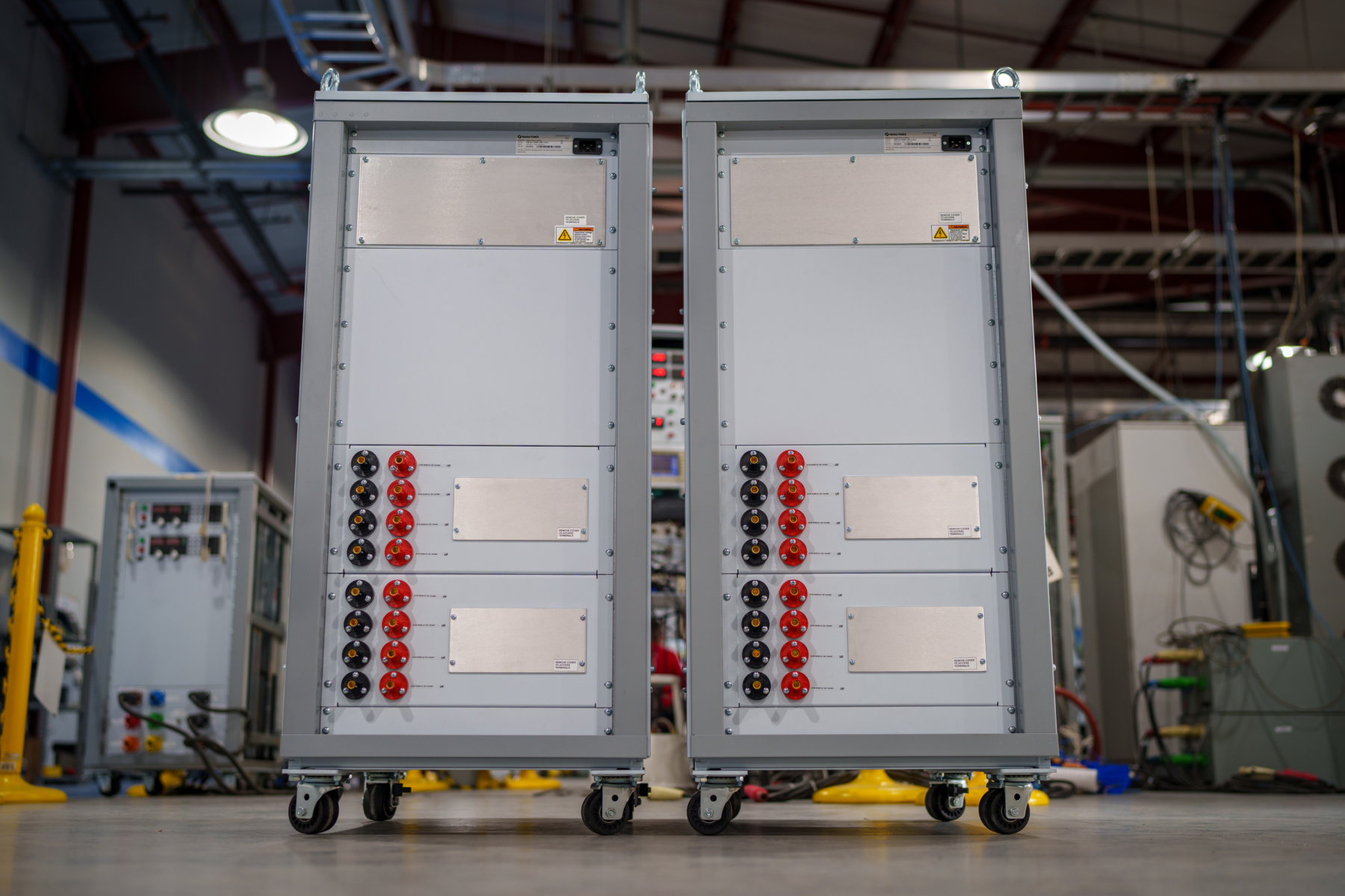Sixteen sets of panelized Hubbell DC power connectors integrated onto a Magna-Power fabricated custom access panel.